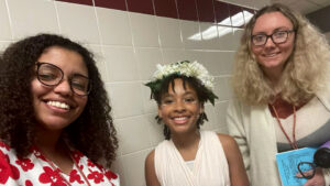 2 women and a young girl smiling at the camera.