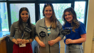 3 women smiling at the camera with motivational quotes in front of them.