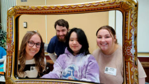 a group of people smiling at the camera with a frame around them